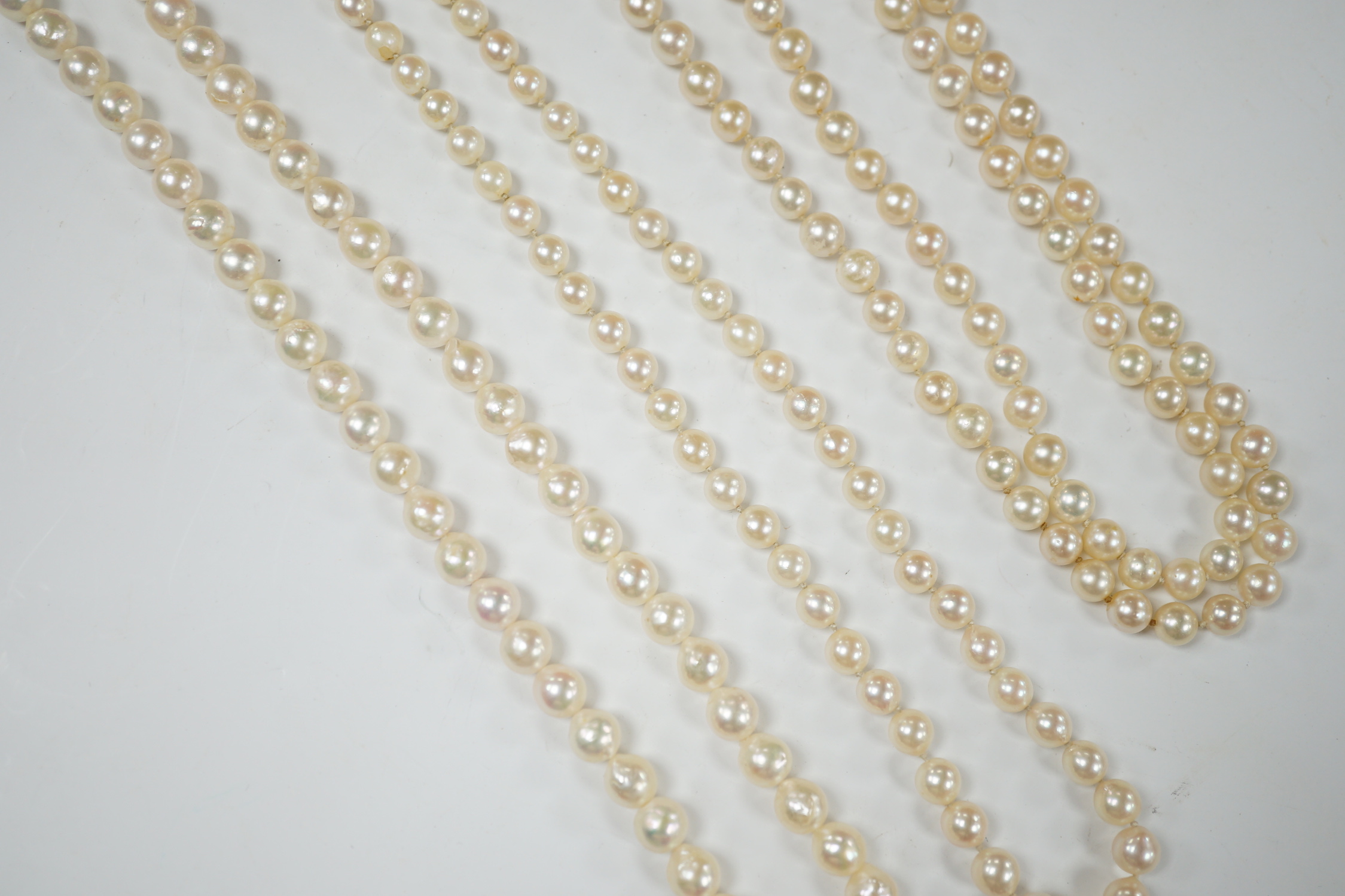 Three assorted modern single strand cultured pearl necklaces, one with 585 clasp, longest 76cm.